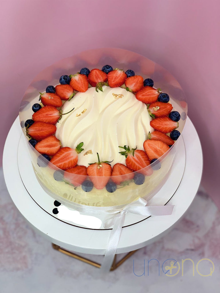 Creamy cheesecake topped with fresh strawberries and blueberries