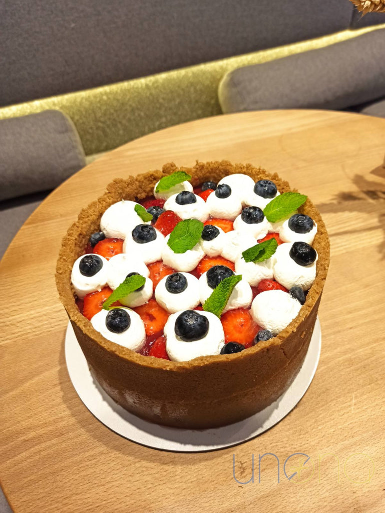 Rich and creamy cheesecake decorated with whipped cream and fresh berries