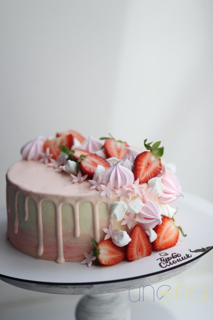 Handmade strawberry cake decorated with fresh strawberries and pastel sugar blossoms