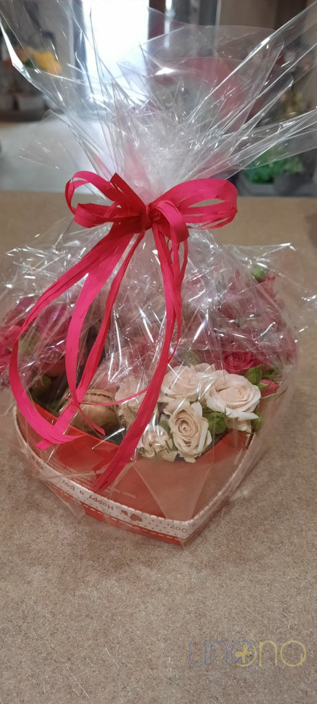 Luxury heart-shaped gift box with flowers and sweets
