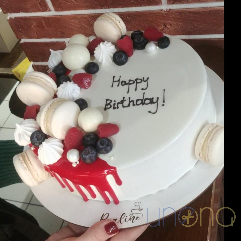 Birthday cake decorated with colorful French macarons