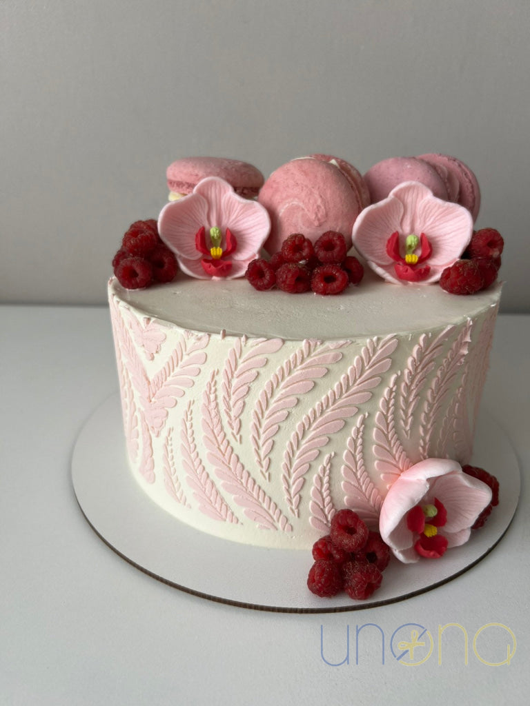 Birthday cake with orchids, macarons and cream
