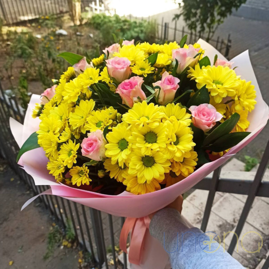 Pink roses with light yellow chrysanthemums in a romantic bouquet