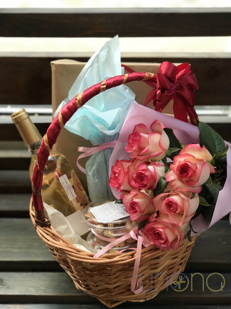 Romantic gift basket with fresh roses, wine and gourmet chocolates for delivery in Ukraine