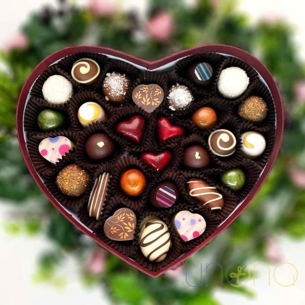Romantic heart-shaped red box of artisan chocolates featuring a wooden "Love You" sign in Ukrainian