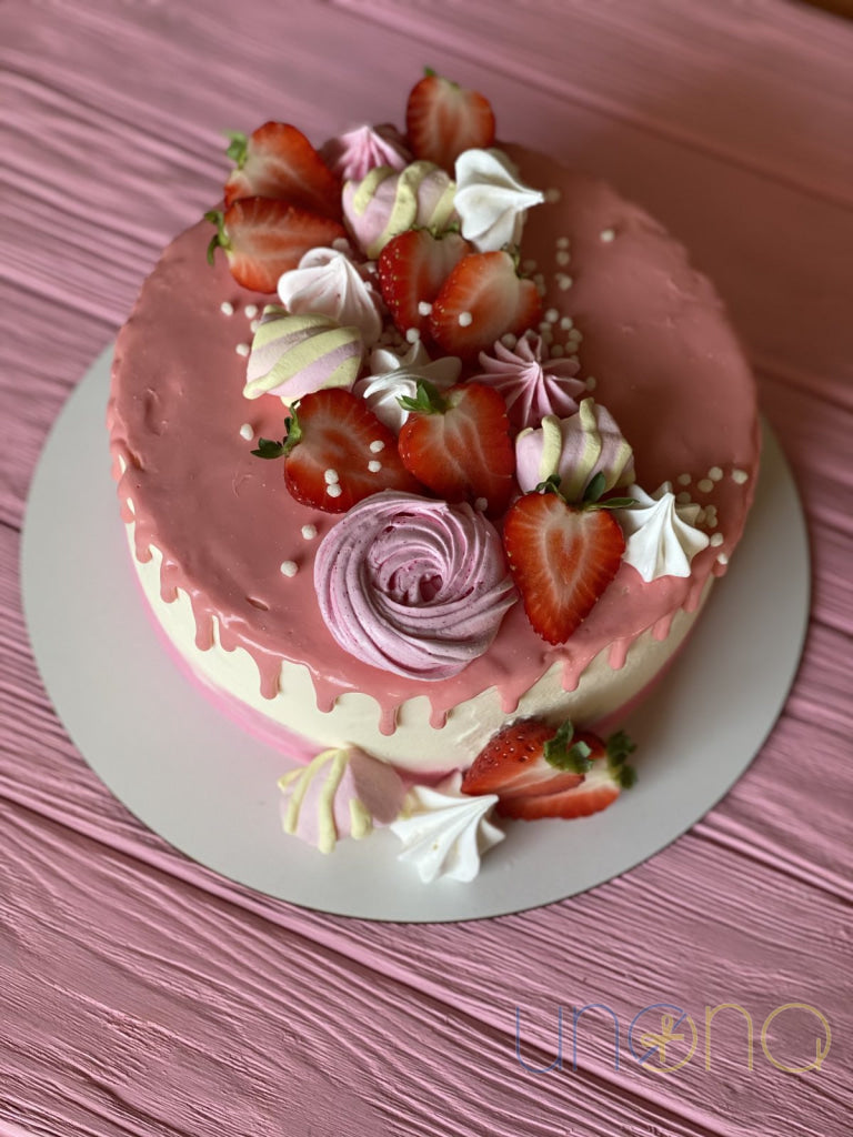 Elegant strawberry birthday cake with fresh strawberries and buttercream decoration