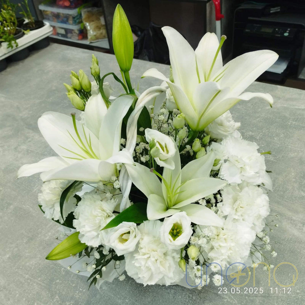 Chic white floral arrangement in a basket featuring gladioluses, carnations, and alstroemerias – same-day delivery in Ukraine