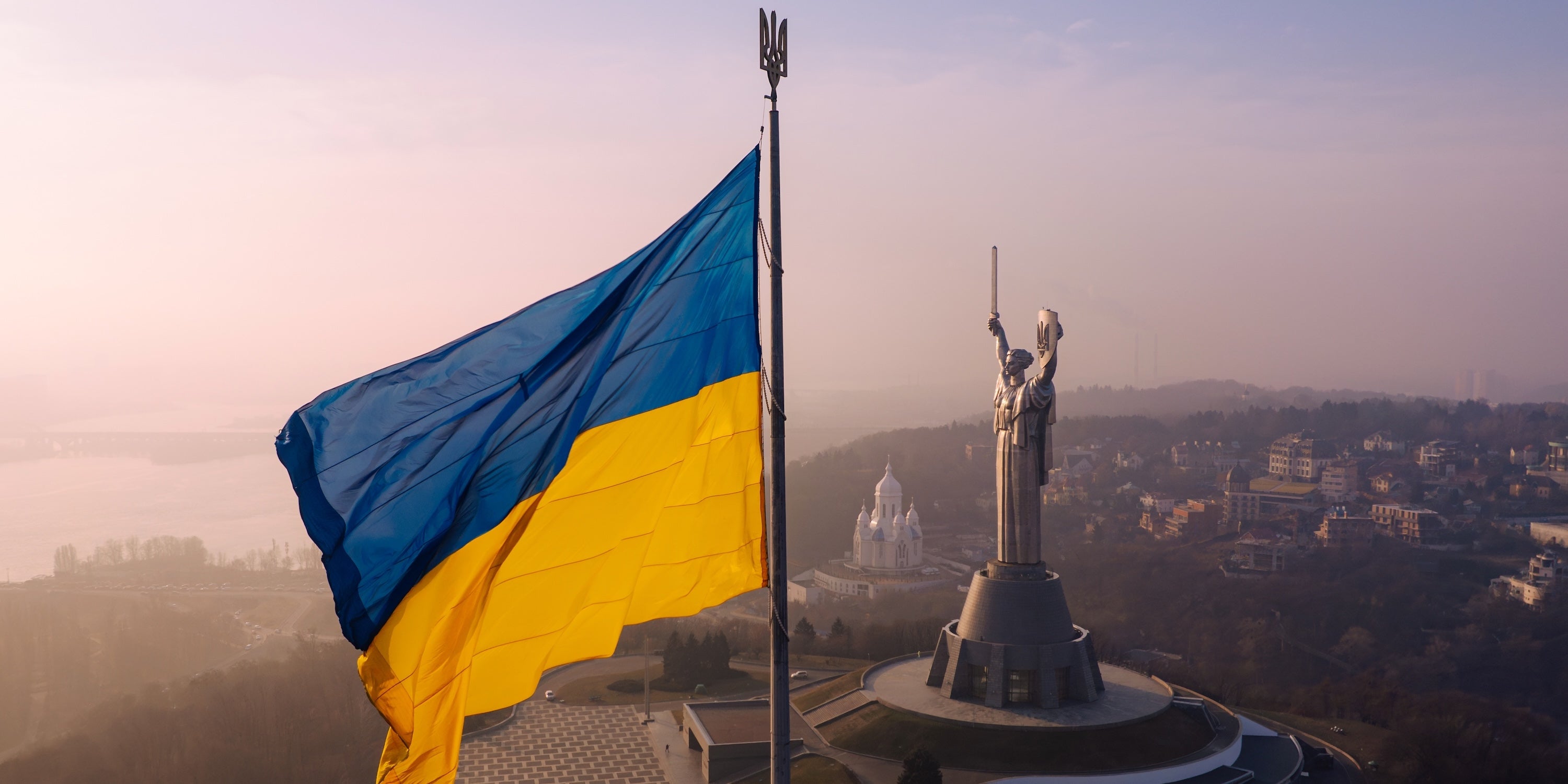 Ukrainian national flag flying before the Motherland Monument in Kyiv