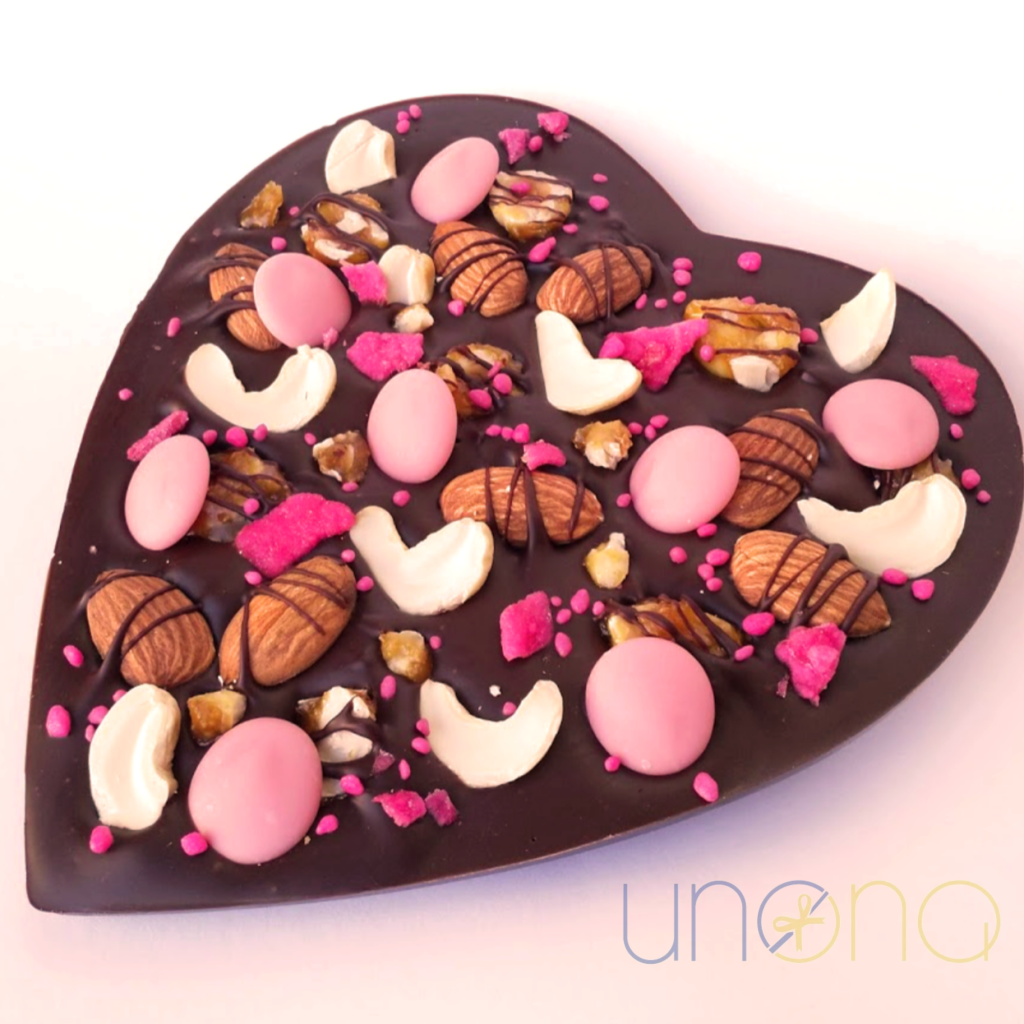 Artisan heart-shaped Belgian dark chocolate bar handcrafted with roasted nuts, berry chocolate, and floral decorations