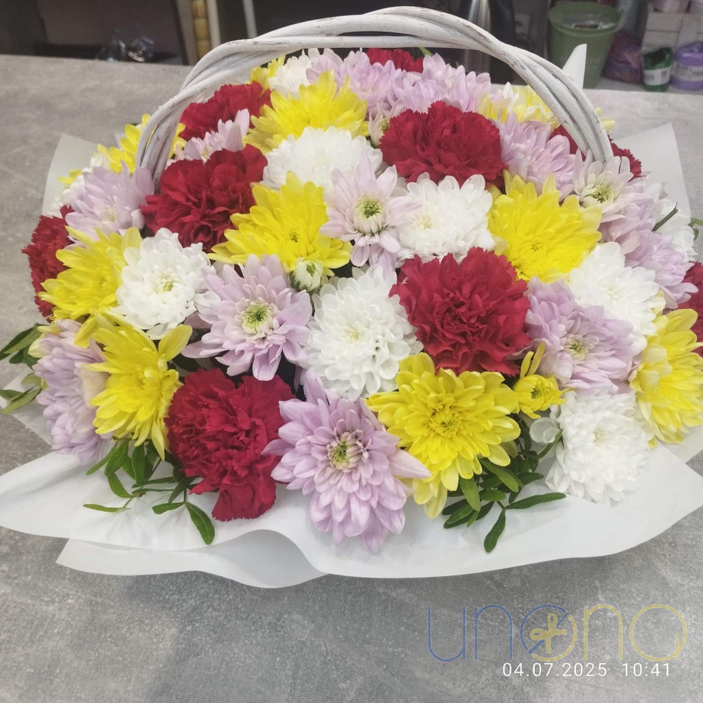 Bright basket arrangement of fluffy asters in vibrant autumn shades with elegant wrapping