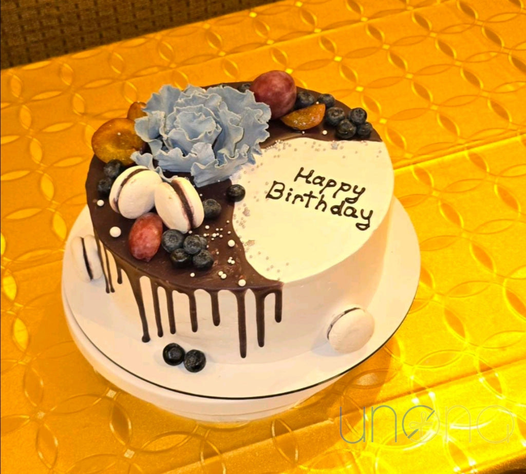 Celebration cake decorated with authentic French macarons