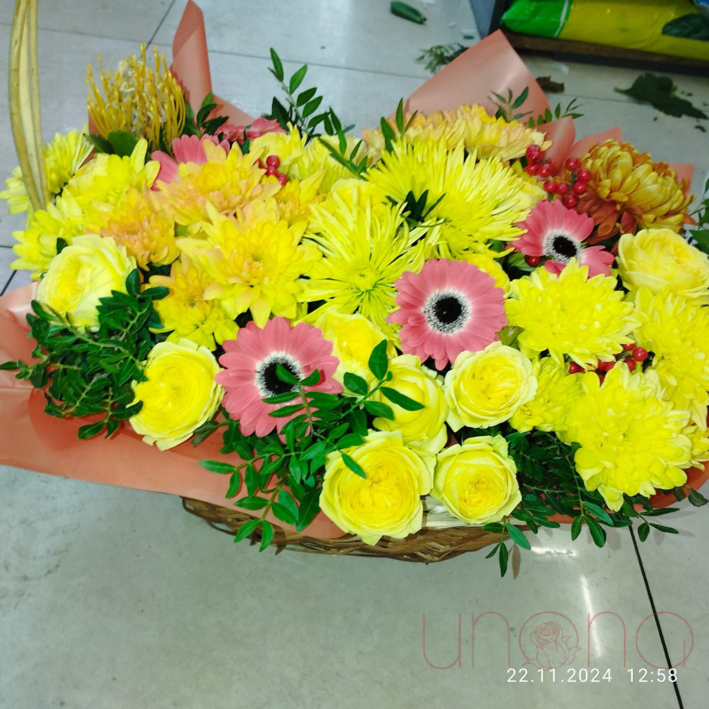 Chrysanthemums and roses in an elegant flower basket