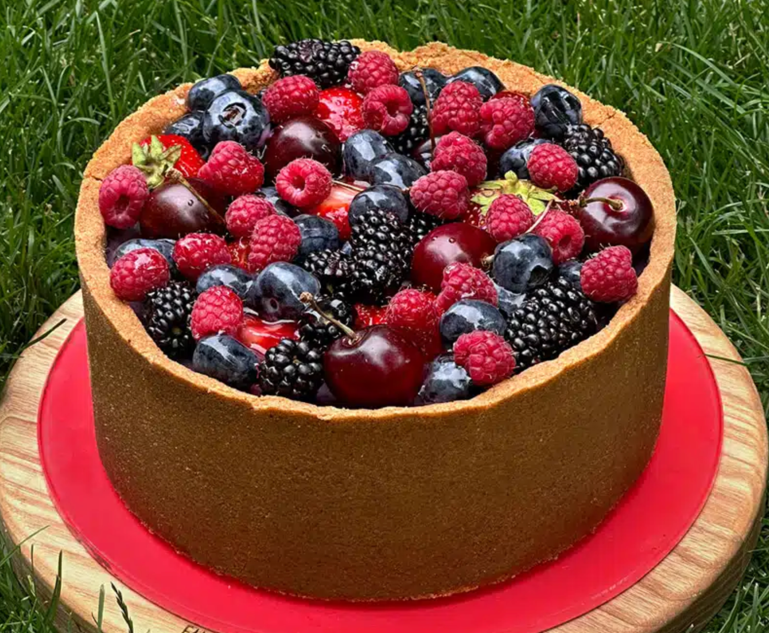 Rich and creamy cheesecake decorated with whipped cream and fresh berries