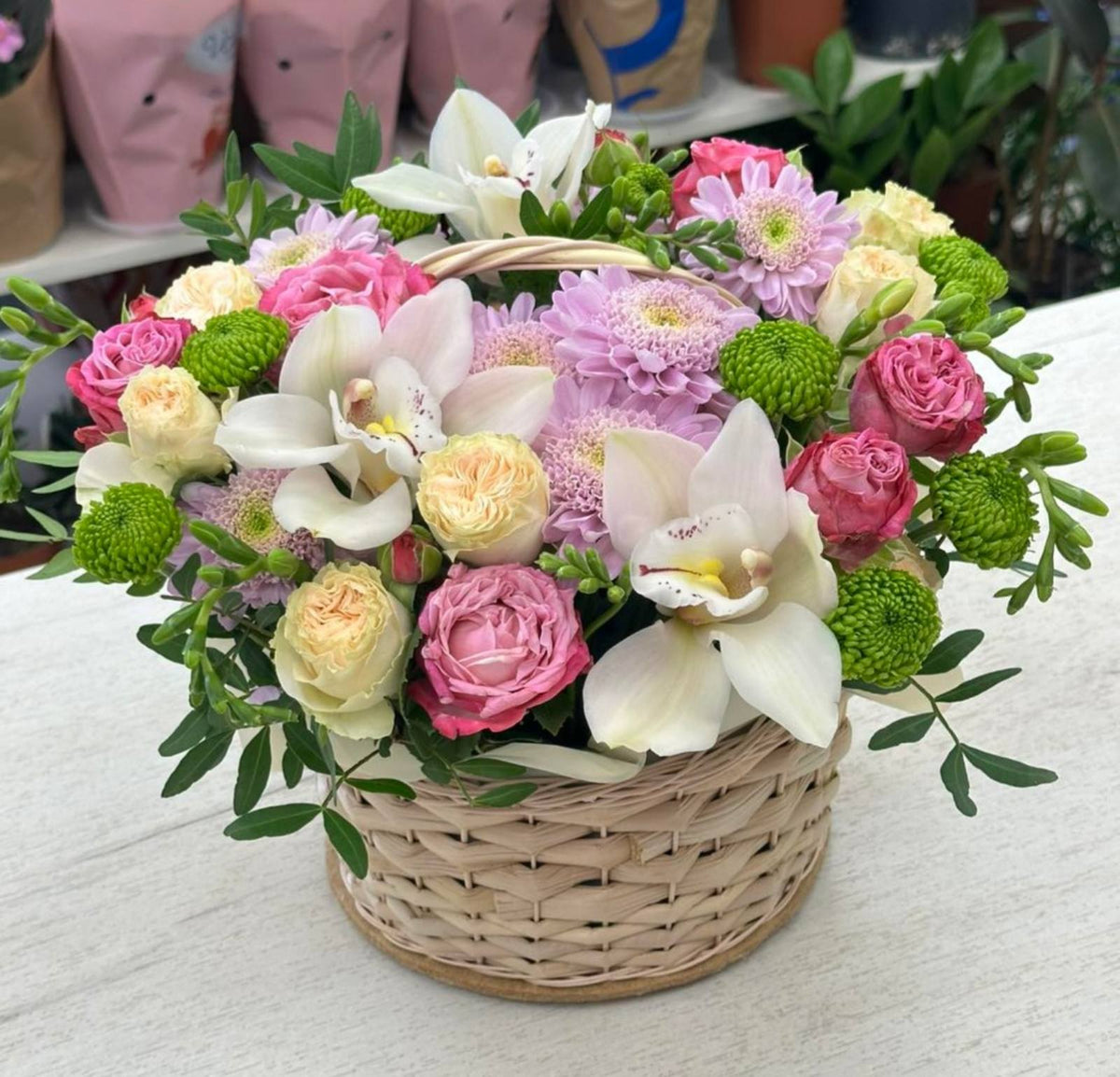 Elegant mixed flower basket with roses orchids and chrysanthemums