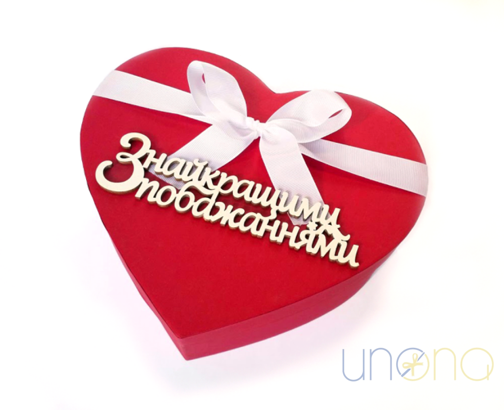 French macarons arranged in a heart-shaped gift box