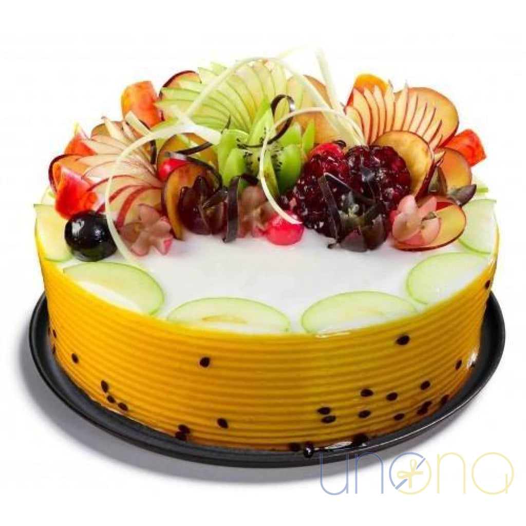 Elegant fruit cake topped with seasonal fruits and glossy glaze