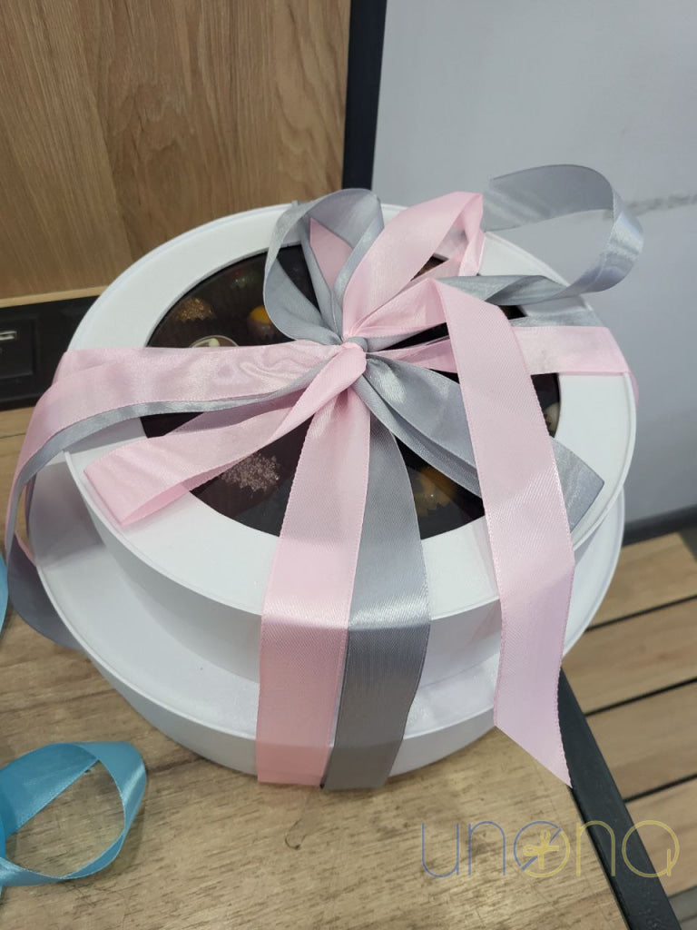Gourmet dessert tower with chocolates and macarons
