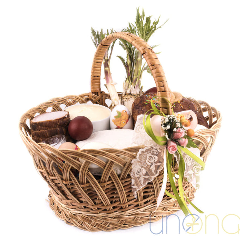 Grand Easter basket with paska cheese meat wine and candles Ukraine