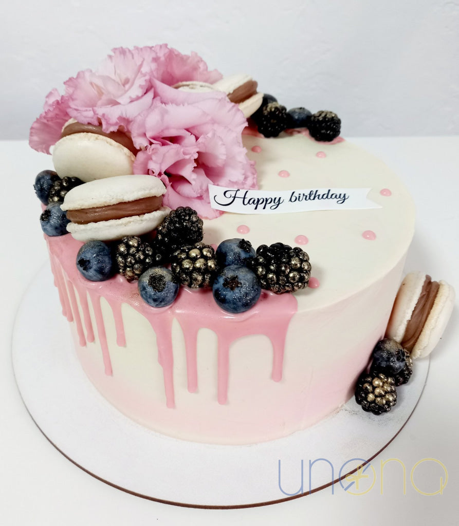 Happy Birthday cake with personalized inscription and macarons