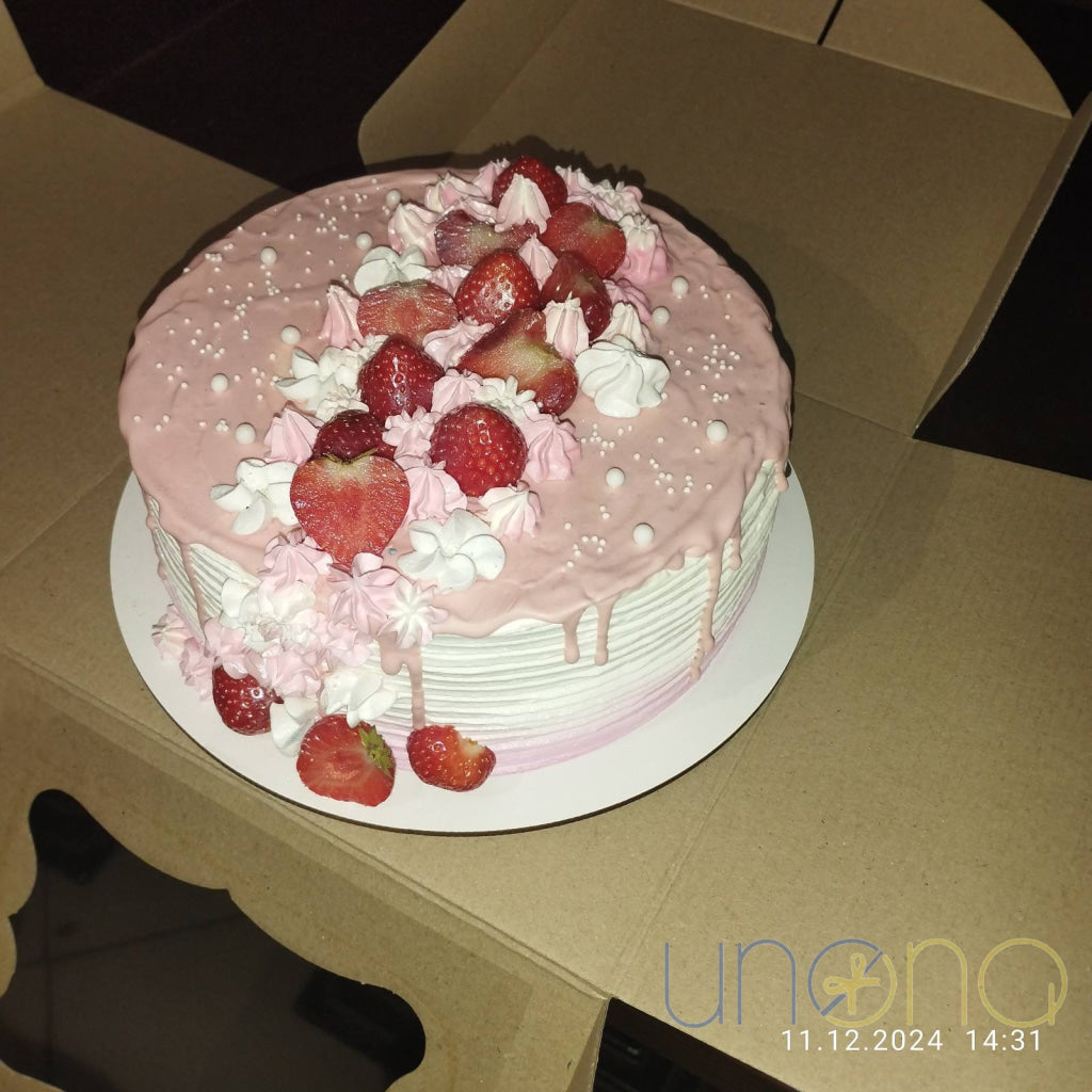 Luxury strawberry cake with cascading buttercream decoration and fresh strawberries