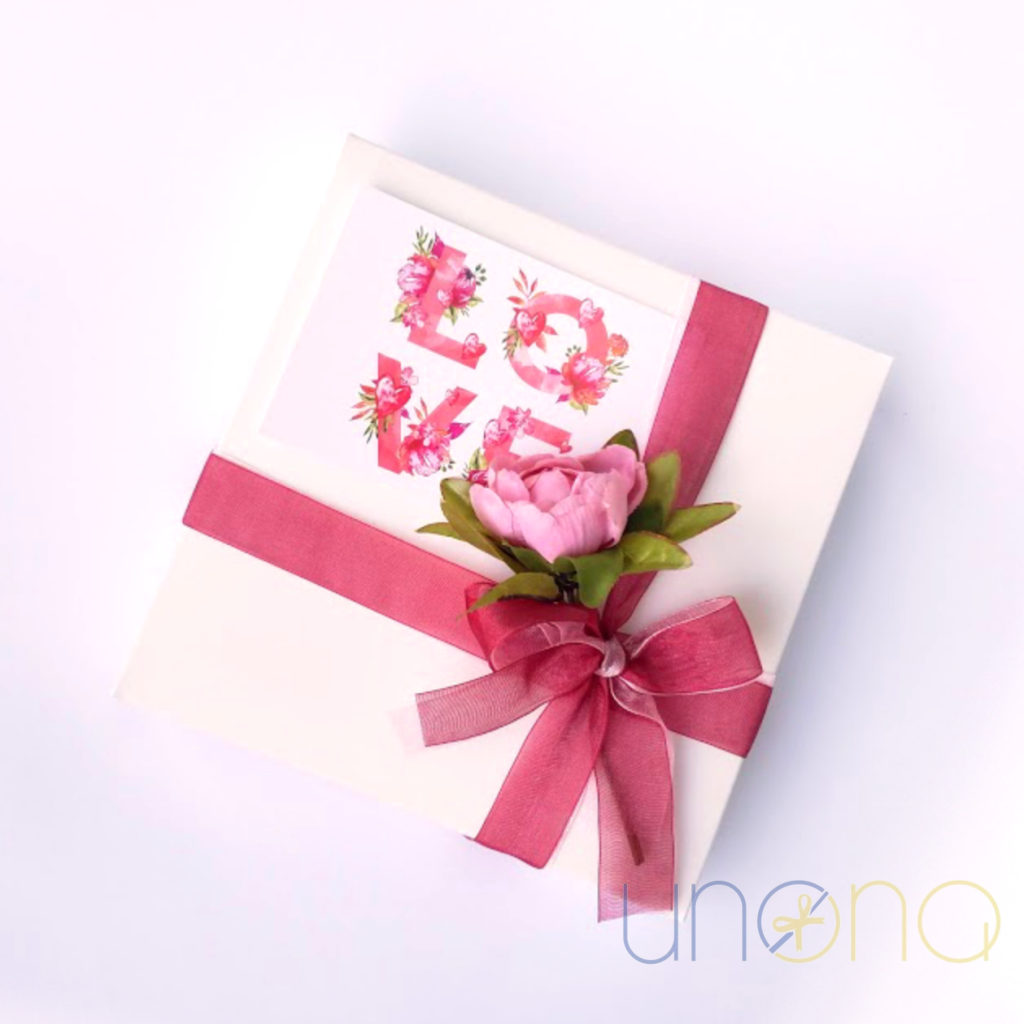 Romantic heart-shaped artisan chocolate bar with almonds, hazelnuts, cashews, and edible rose petals