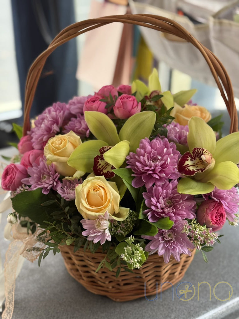 Orchids roses and chrysanthemums in an elegant wicker basket