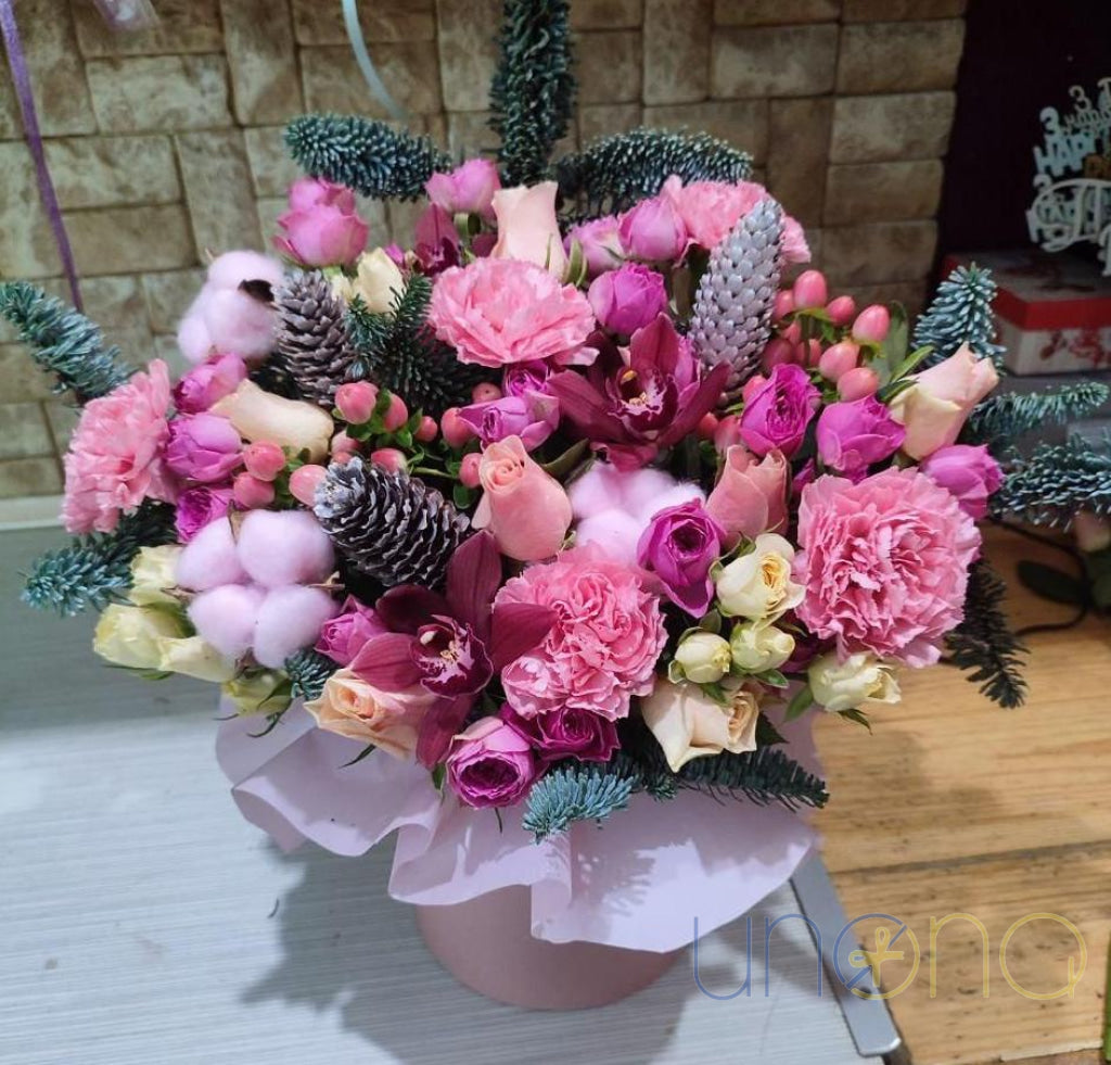 Elegant boxed bouquet with roses, carnations and seasonal greenery