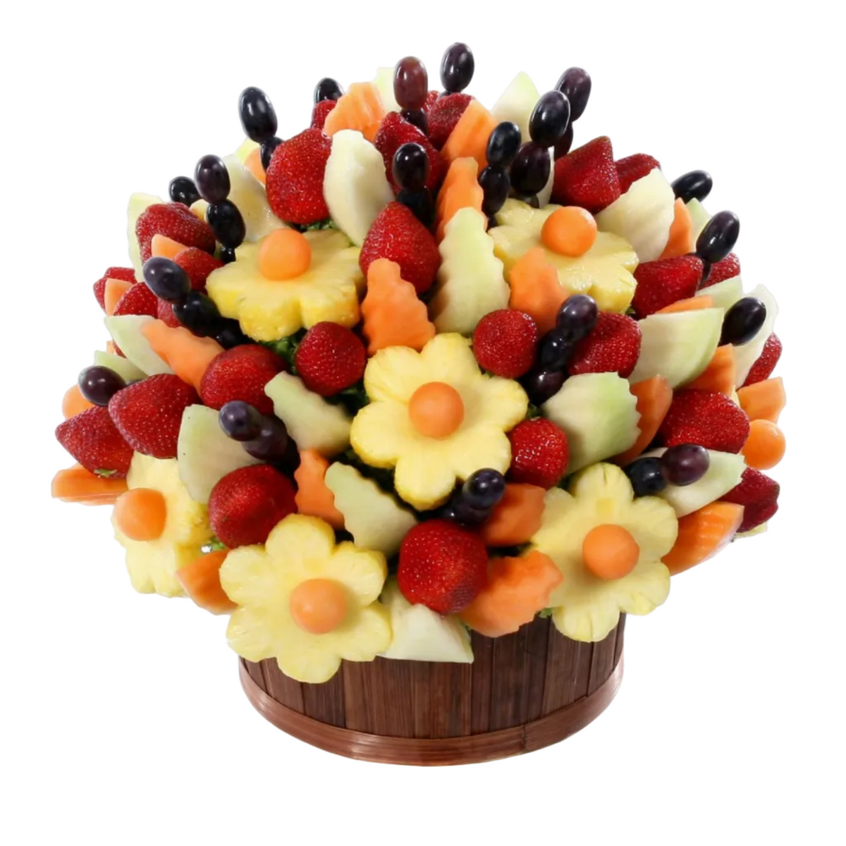 True Abundance fruit bouquet with pineapple flowers, strawberries, grapes and melon in a red container