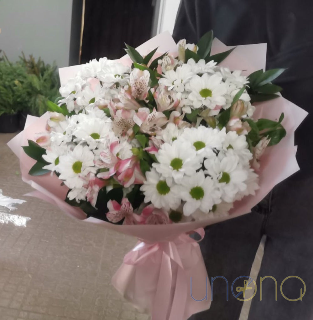 White chrysanthemums with soft pink alstroemerias in an elegant bouquet