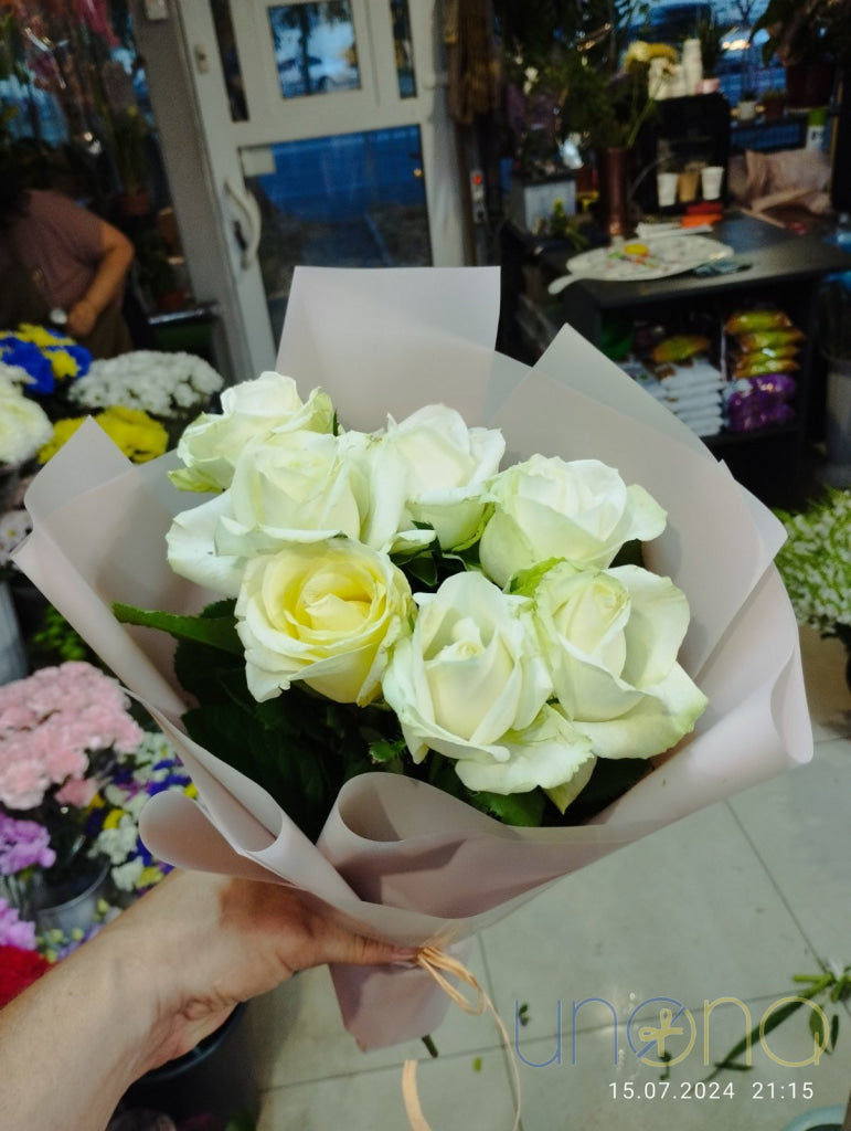Fresh white roses professionally arranged by local florists in Kyiv