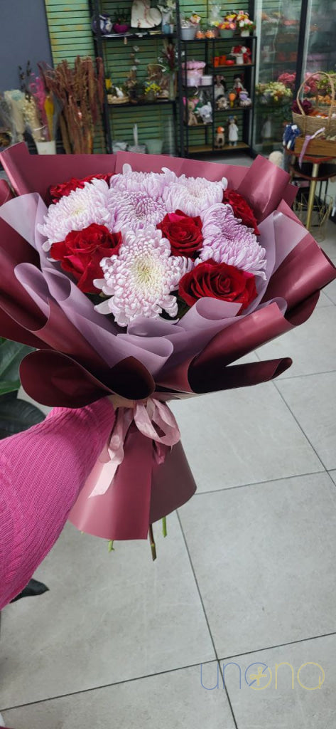 Yellow chrysanthemums with red and orange roses to send to Ukraine